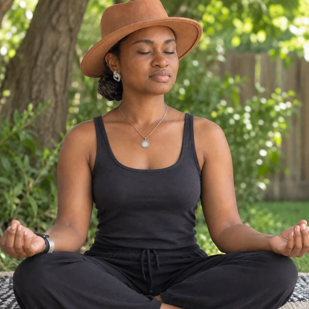 Shaun meditating outdoors in a peaceful garden